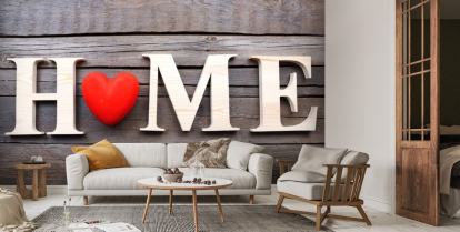 Decorative letters forming word HOME with heart on wooden